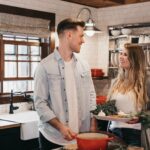 man and woman standing inside kitchen room