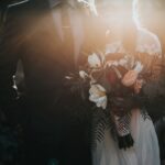 groom beside bride holding bouquet flowers