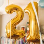 brass-colored 21 foil balloons inside room