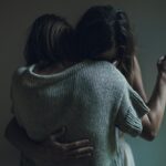 two women hugging each other