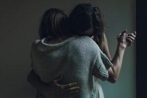 two women hugging each other