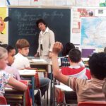 woman standing in front of children